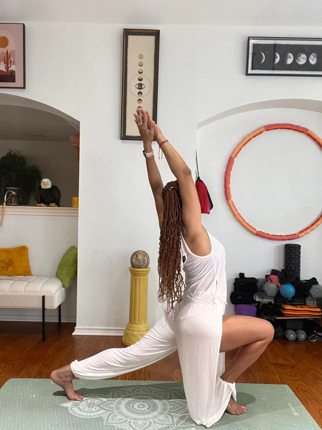 Woman mid-stretch in a bright studio with warm side light